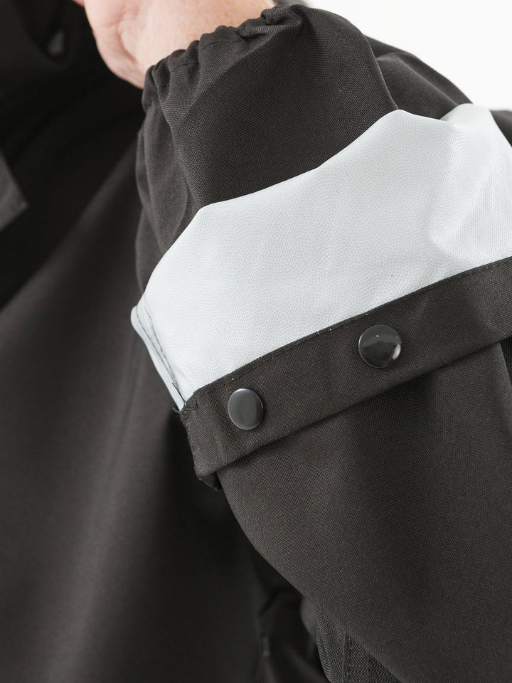 Features double-protection elastic and button-snapped cuffs